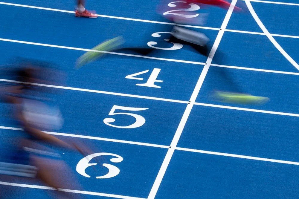 A shot of the lanes at Scotstoun Stadium in Glasgow, with blurred features of the runners.