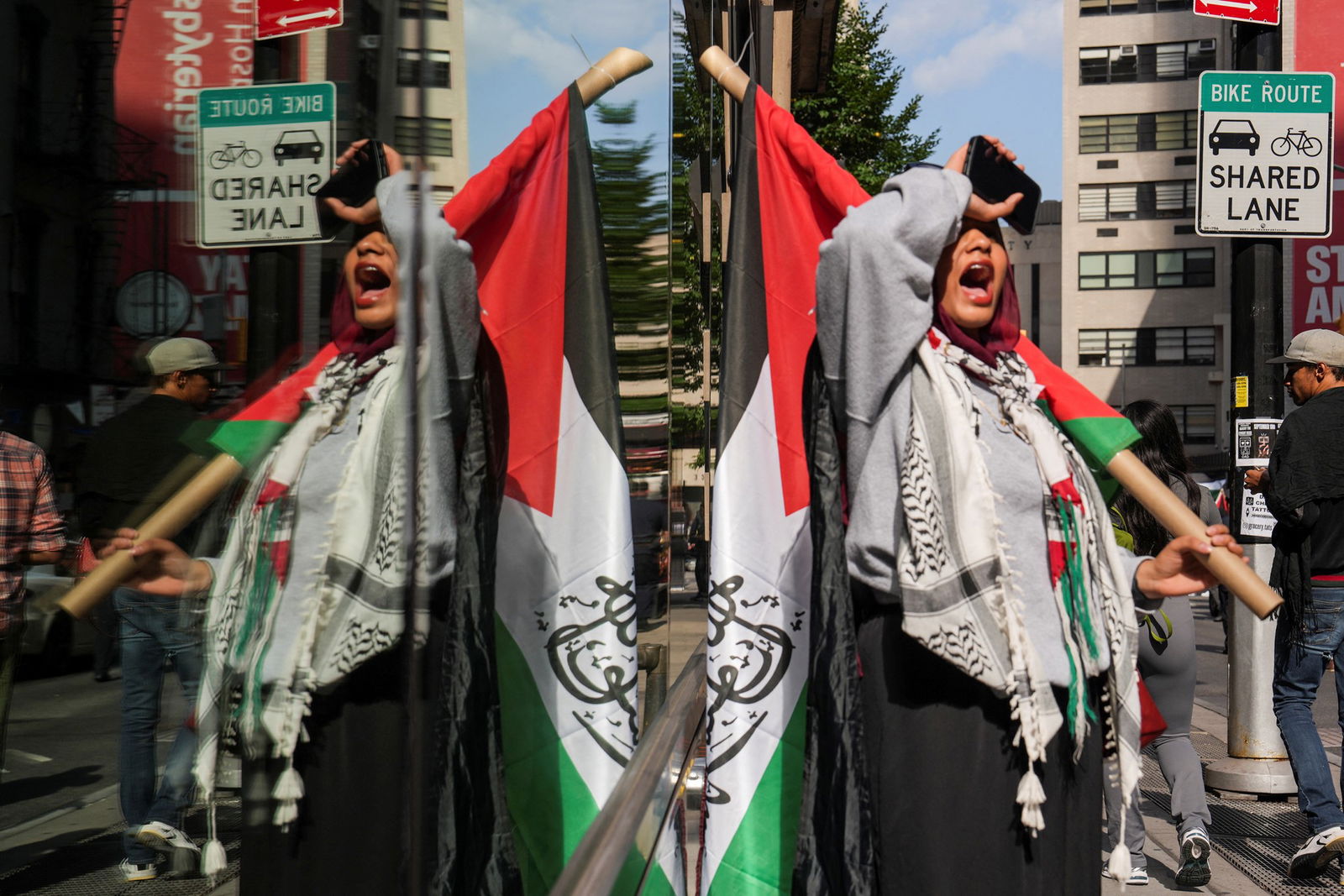 A person holding a palestine flag. 