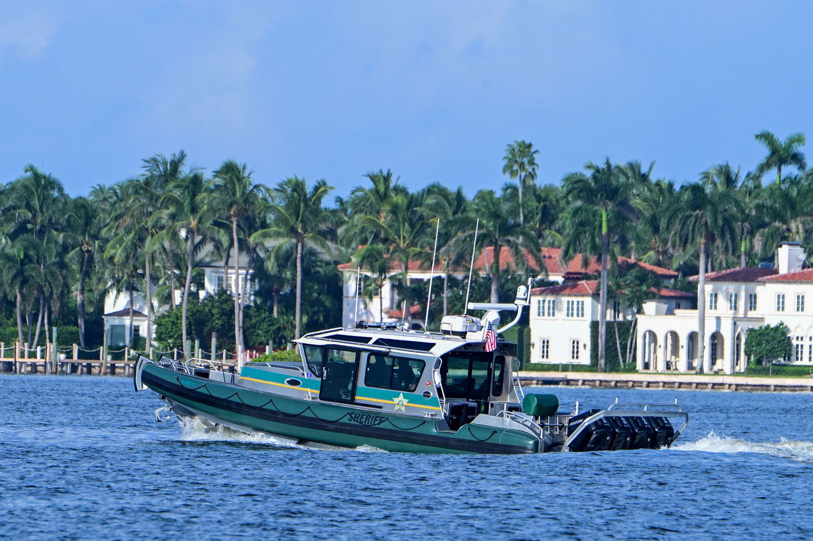 A green police baot patrols the water 